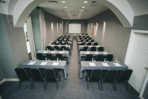 a large room with tables and chairs in it at Hotel Zenit Budapest Palace in Budapest