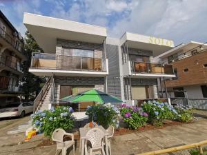 a building with a green umbrella in front of it at Solo apartments in Ureki
