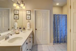 a bathroom with a sink and a blue shower curtain at Helen Hilltop Haven in Helen +31 photos