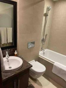 a bathroom with a sink and a toilet and a tub at Three bedroom apartment in Saadiyat district in Abu Dhabi