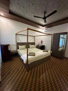 a bedroom with a bed with a canopy at Patnem Beach Cottages in Patnem