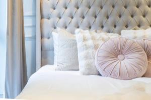 a bedroom with a white bed with a metal headboard at Chelsea Harbour Living in London