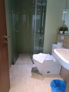 a bathroom with a shower and a toilet and a sink at vortex klcc RR in Kuala Lumpur