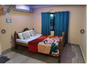 1 dormitorio con 1 cama con cortinas azules en Similipal Eco Retreat, Baripada, Odisha, en Bālidiha