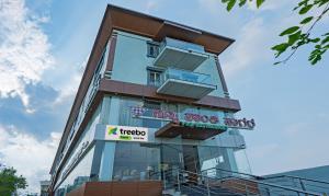 a tall building with a sign on it at Treebo Trend Globel Stay - Uttarahalli in Bangalore
