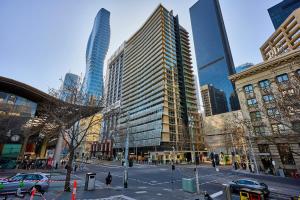 a city with tall buildings and a street with cars at Collins Street City Stay - 2 Min to Southern Cross in Melbourne