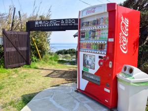 een cocacola machine staat geparkeerd naast een vuilnisbak bij Tonosaki Bungalow & BBQ - Vacation STAY 29542v in Tsushima