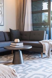 a living room with a couch and a coffee table at Casa on Bantry by Totalstay in Cape Town