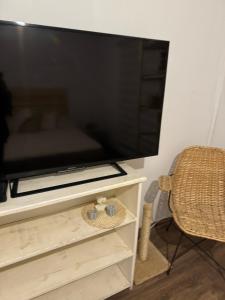 a large flat screen tv sitting on a entertainment center at Unica y mágica casa Ocean Park in Ocean Park