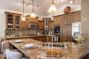 a kitchen with wooden cabinets and a counter with a sink at Benchview in Ogden