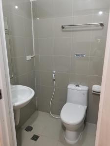 a bathroom with a toilet and a sink at Modern 1BR with balcony and 100mbps wifi in Manila