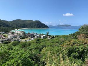 a view of a resort and the ocean at HOTEL KANALOA in Tokashiki