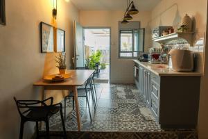 a kitchen with a table and chairs in a room at 54You in Ahuzat Barak