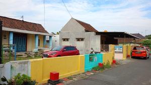 a red car parked in front of a house at SPOT ON 93712 Vanda Family in Blitar