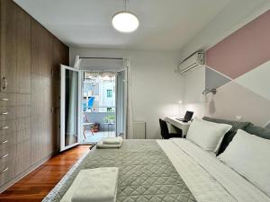 a bedroom with a large bed and a desk at Two bedroom luxury apartment. in Athens