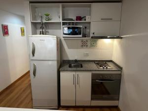 a small kitchen with a refrigerator and a sink at Av Julio A Roca - Monserrat in Buenos Aires