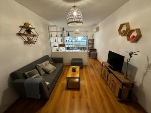 a living room with a couch and a television at Av Julio A Roca - Monserrat in Buenos Aires