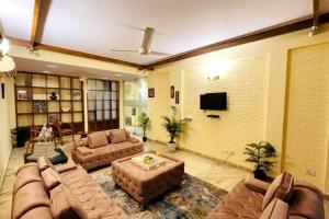 a large living room with couches and a flat screen tv at Divine India Service Apartment 4Bhk,D-36, Saket in New Delhi