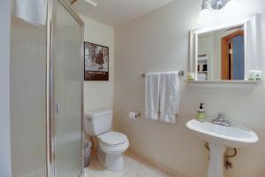 a white bathroom with a toilet and a sink at Forest Haven in Sisters +28 photos