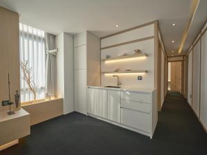 a bathroom with a sink and a mirror at UH Suite The Seoul in Seoul