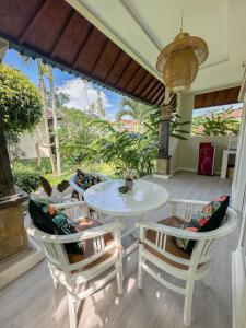 a patio with a white table and two chairs at villa senyum in Canggu