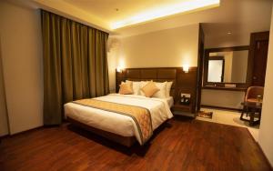 a bedroom with a large bed and a mirror at NAR Comforts in Bangalore