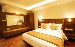 a bedroom with a large bed and a mirror at NAR Comforts in Bangalore