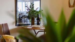 a table with a bottle of beer and flowers on it at Lakeside Suite 1 - Lake View & Spa Bath in Daylesford
