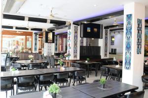a dining room with tables and chairs and tablesktop at Diamond Crown in Patong Beach