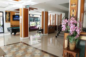 a lobby with a pool table and a vase of flowers at Diamond Crown in Patong Beach