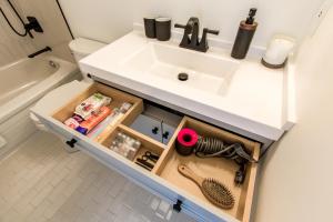 a bathroom sink with a drawer under it with tools at lovely 1-bedroom w/parking at Coal Harbour in Vancouver