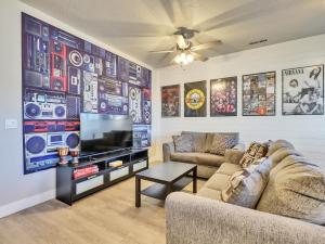 a living room with two couches and a flat screen tv at Band Camp Town Home in Cedar City