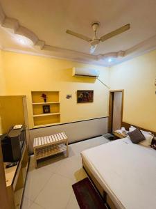 a room with a bed and a tv in it at Hotel Payal Jaisalmer in Jaisalmer