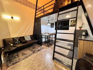 a loft apartment with a couch and a table at M Villa Staycation in Los Baños