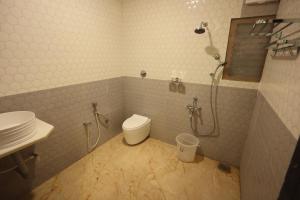 a bathroom with a shower and a toilet and a sink at Kailasaa Residency in Tiruvannāmalai