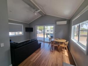 a living room with a couch and a table at Gulgong Tourist Park in Gulgong