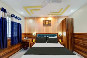 a bedroom with a large bed with blue curtains at Collection O Hotel Royal Sangrila in Patna