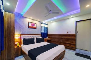 a bedroom with a bed and a ceiling with lights at Collection O Hotel Royal Sangrila in Patna