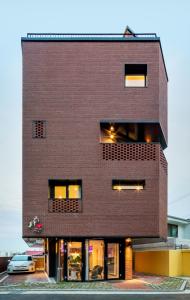 a brick building with windows and a car at Space in Blackstone in Seoul