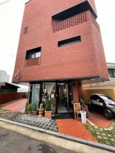 a red brick house with a car parked in front of it at Space in Blackstone in Seoul
