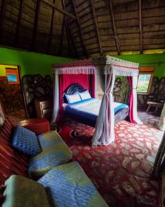 a bedroom with a bed with a canopy at Paradise Eco-Hub in Kabale