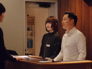 a man and a woman standing in front of a counter at OTHER SPACE Asakusa in Tokyo