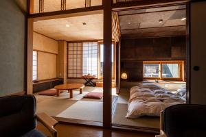a bedroom with a large bed and a table at Sanyoan in Otofuke
