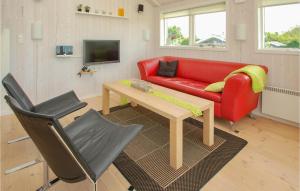 a living room with a red couch and a table at Amazing Home In Haderslev With 4 Bedrooms And Wifi in Flovt