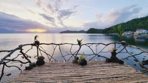 a group of cacti sitting on a wooden bridge over water at Bamboo house for Relaxation in Catbalogan