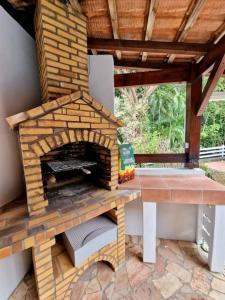 a brick oven sitting on top of a patio at Villa Mahogany confort, spacieuse in Le François
