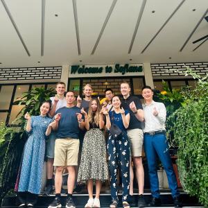 a group of people posing for a picture in front of a building at Sofiana My Khe Hotel & Spa- Rooftop Pool Bar in Danang