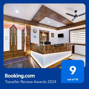 a hotel lobby with a television review awards at Townhouse OAK Ess Jay in Bangalore