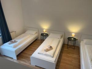 2 camas en una habitación con 2 luces encendidas en Bavaria Home - Küche, Terrasse, 3 Schlafzimmer, en Mainburg