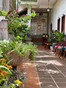 a patio with plants and tables and chairs at Sunset View Guest House in Siem Reap